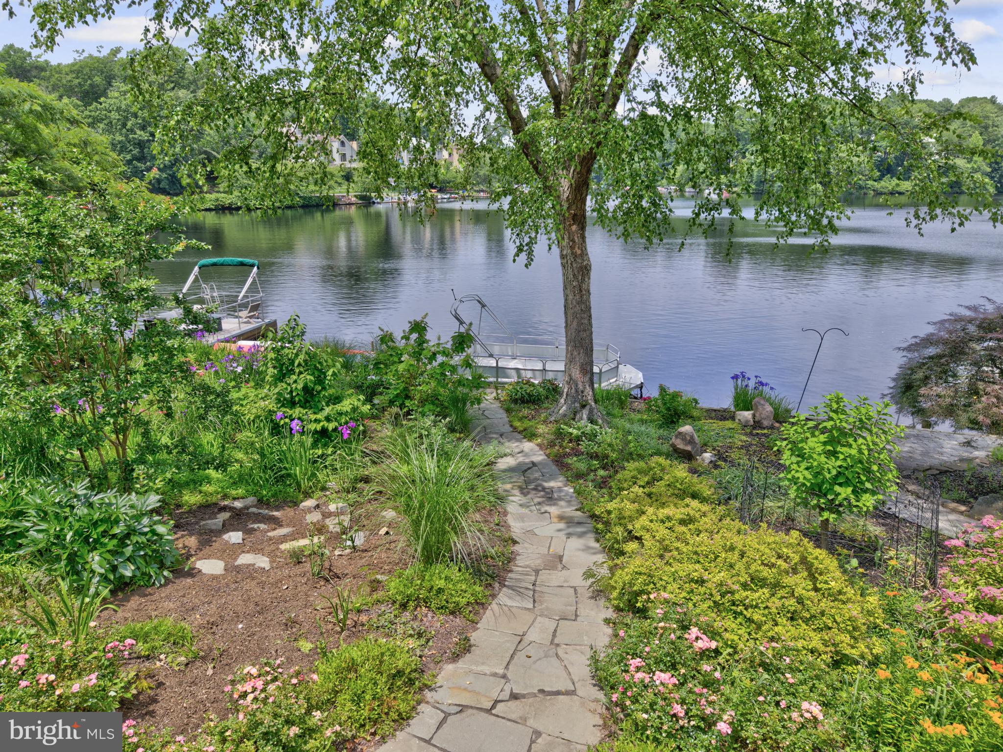 11064 Thrush Ridge Road Reston, VA 20191 - Photo 3 of 85 a view of a lake with a bench next to a lake