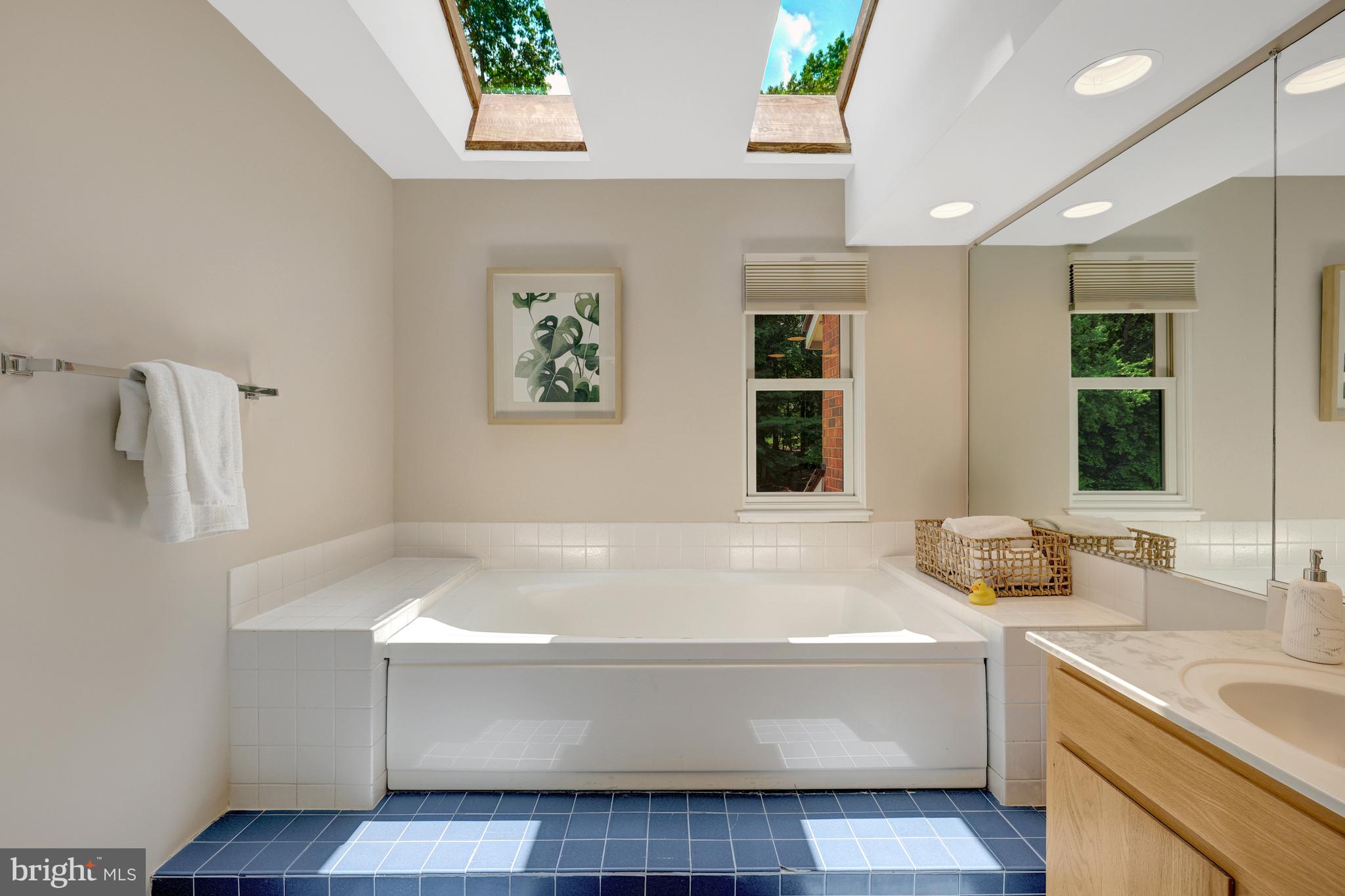 11064 Thrush Ridge Road Reston, VA 20191 - Photo 42 of 85 a bathroom with a tub a sink and a window