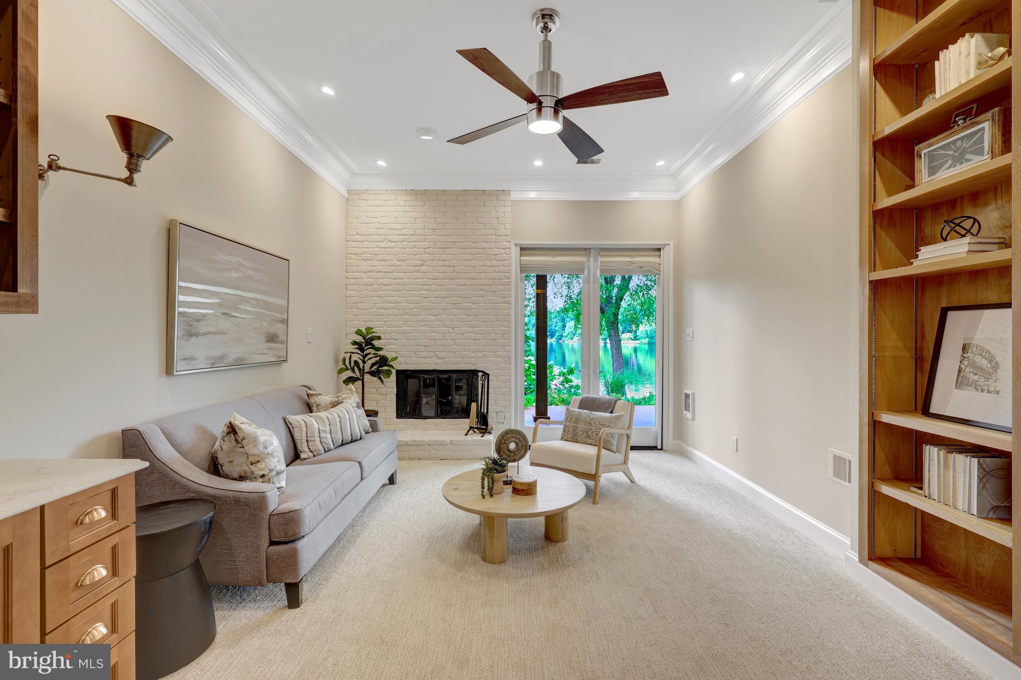 11064 Thrush Ridge Road Reston, VA 20191 - Photo 56 of 85 a living room with furniture a bookshelf and a window