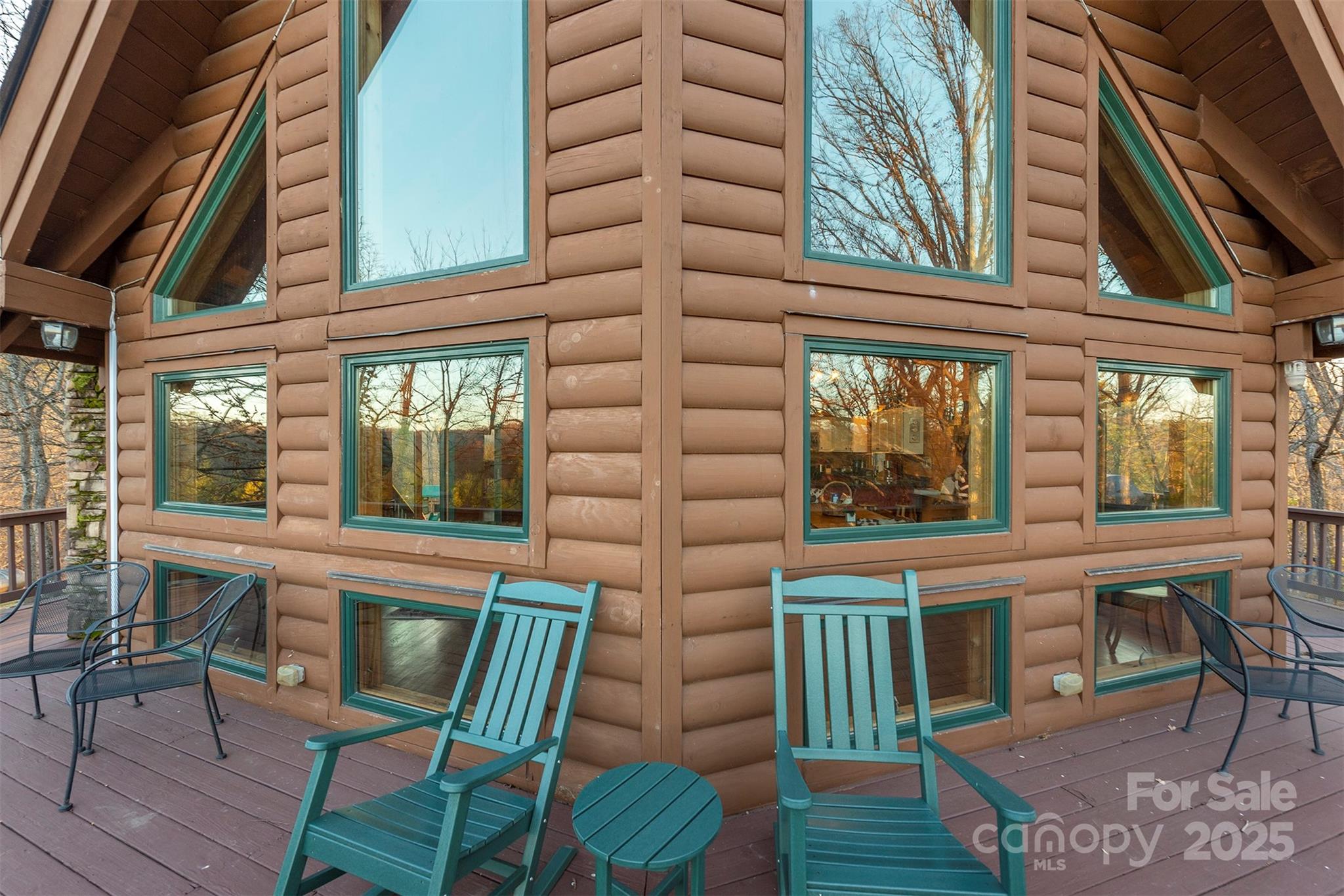 395 Dry Pond Road Marshall, NC 28753 - Photo 11 of 47 a view of a brick house with chairs and table in a patio