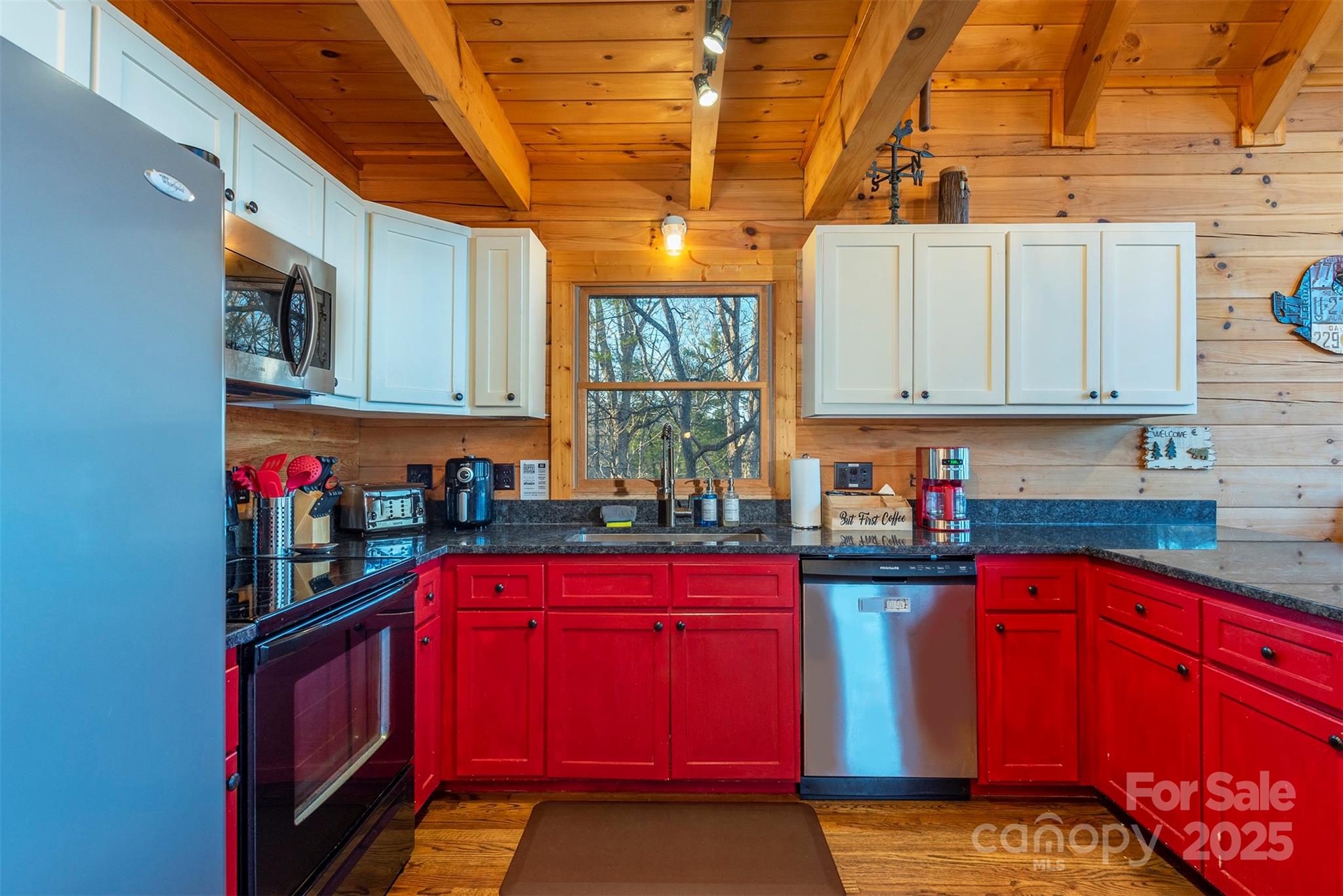 395 Dry Pond Road Marshall, NC 28753 - Photo 22 of 47 a kitchen with stainless steel appliances granite countertop a stove a sink dishwasher and cabinets with wooden floor