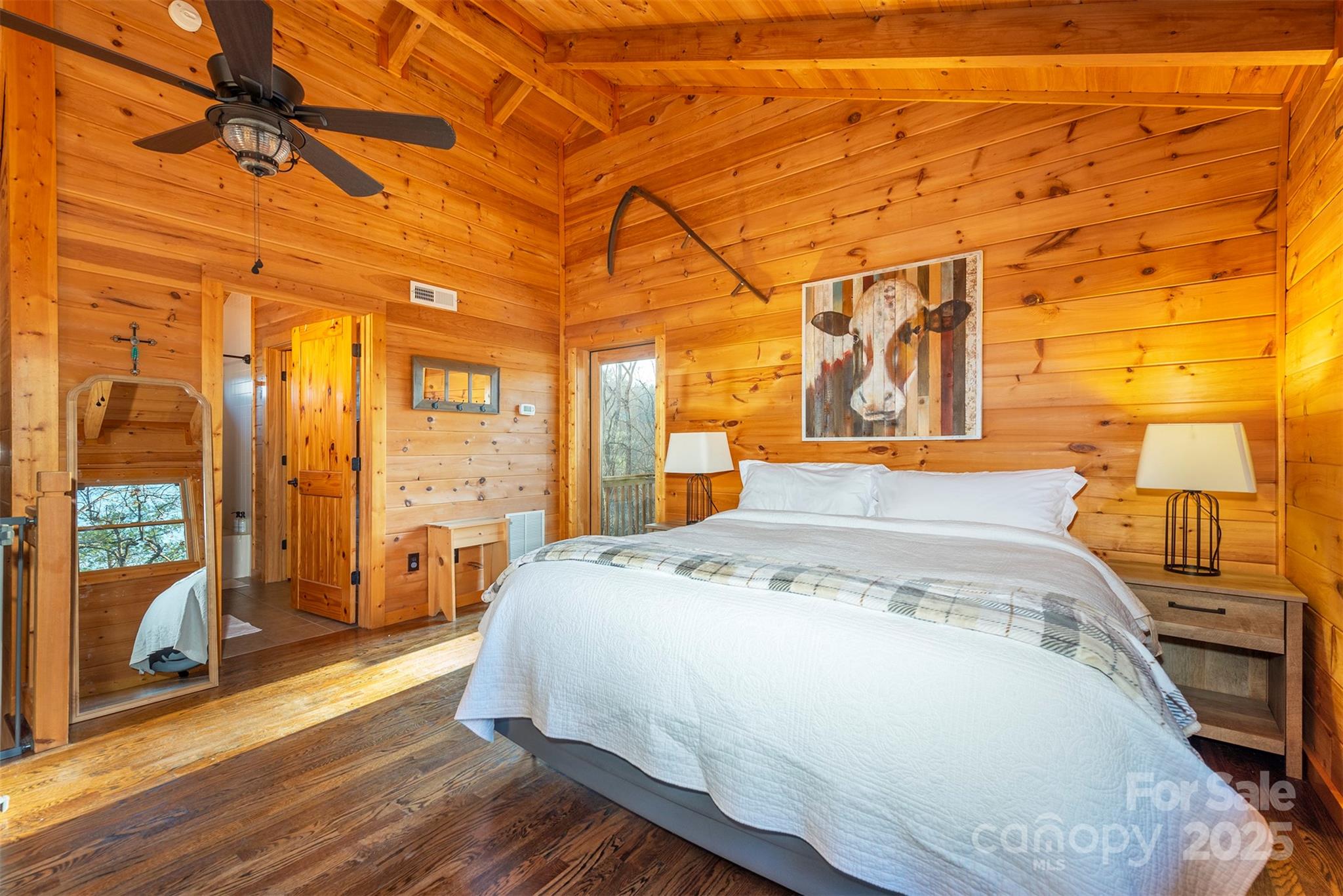395 Dry Pond Road Marshall, NC 28753 - Photo 24 of 47 a spacious bedroom with a bed and wooden floor