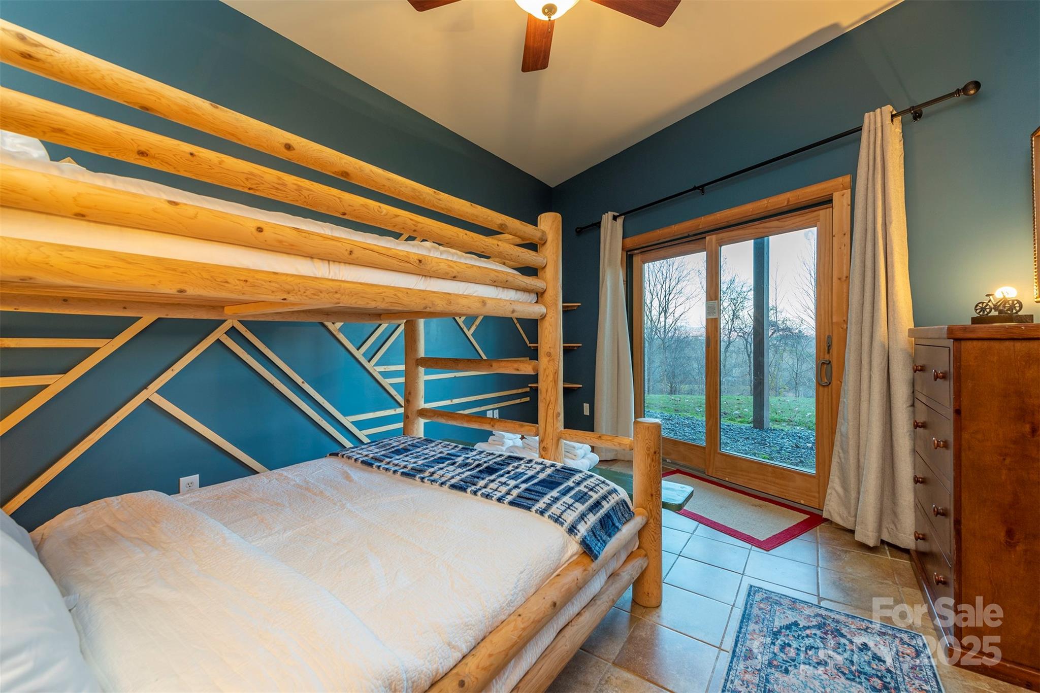 395 Dry Pond Road Marshall, NC 28753 - Photo 33 of 47 a bedroom with a bed and a chandelier