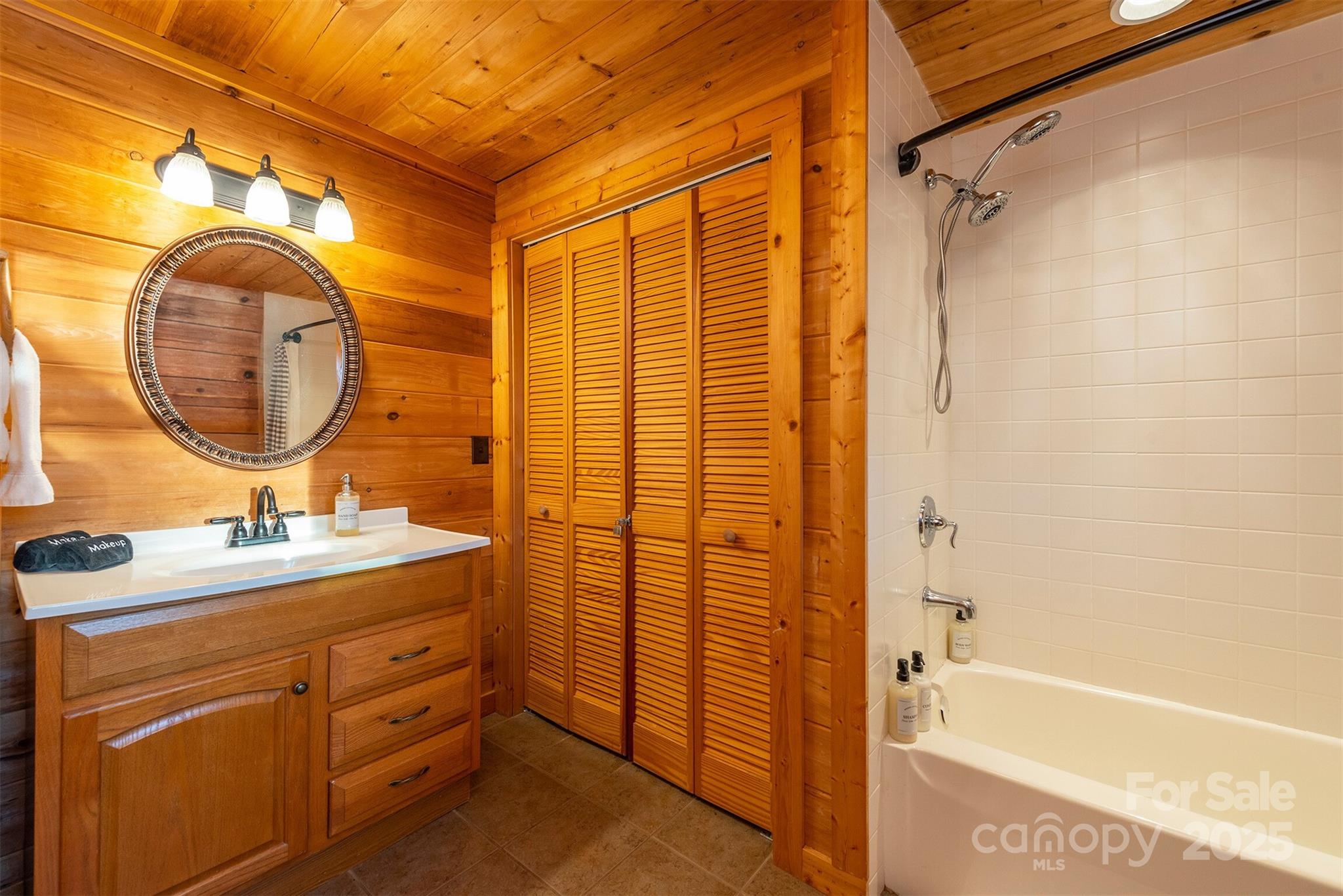 395 Dry Pond Road Marshall, NC 28753 - Photo 39 of 47 a bathroom with a sink a mirror a vanity and a shower