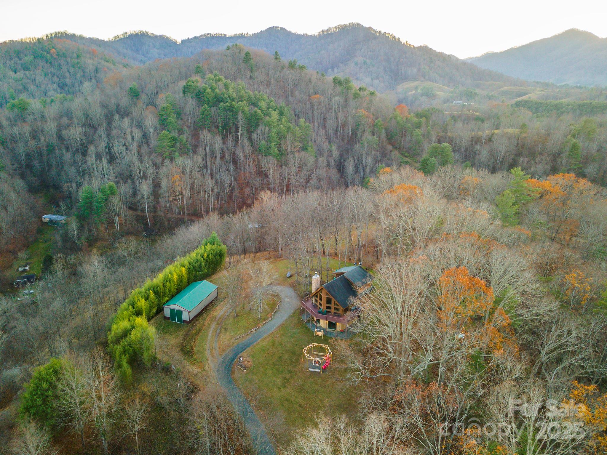 395 Dry Pond Road Marshall, NC 28753 - Photo 41 of 47 a view of a lake with a mountain