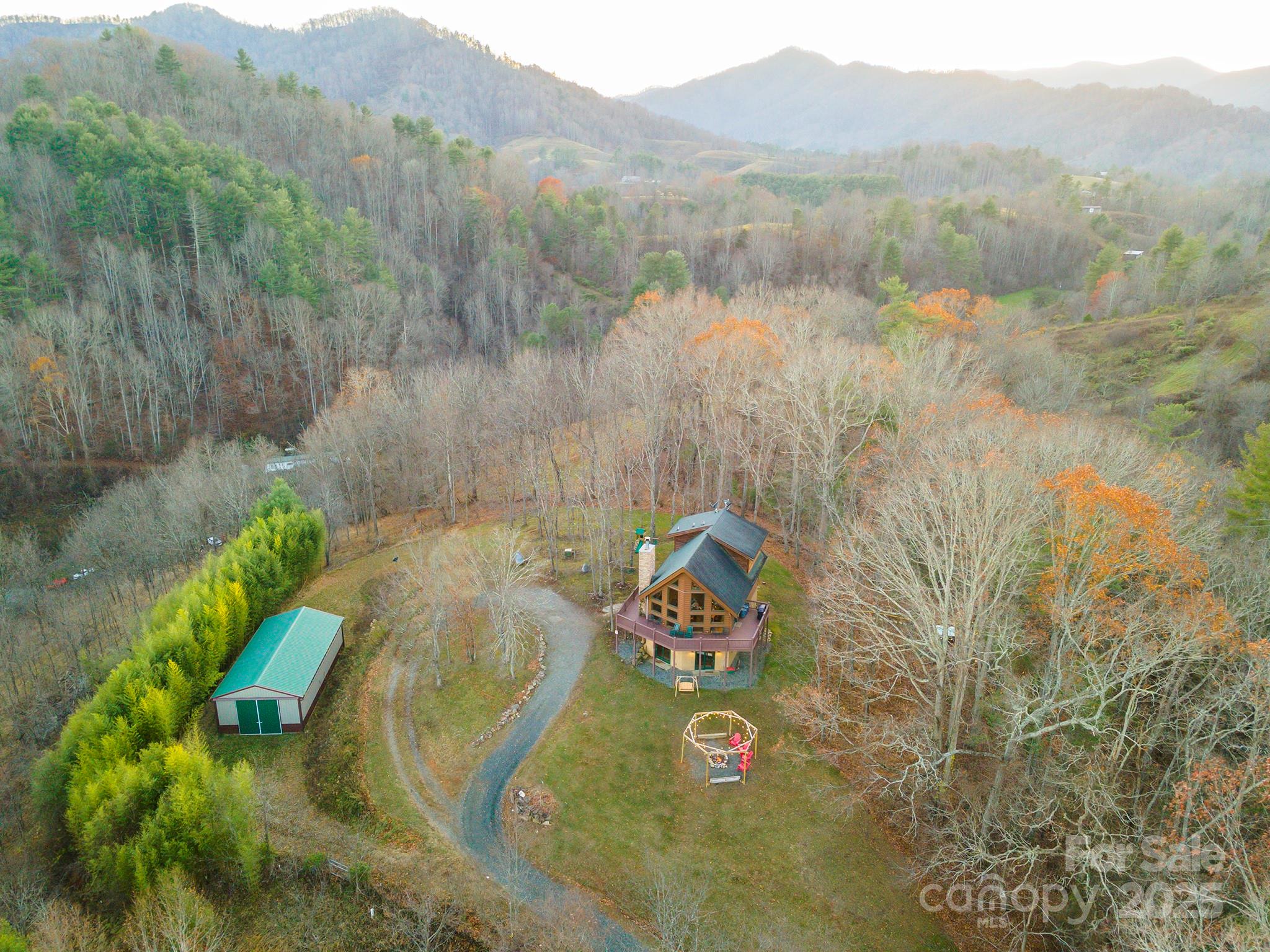 395 Dry Pond Road Marshall, NC 28753 - Photo 42 of 47 a view of a lake with a mountain