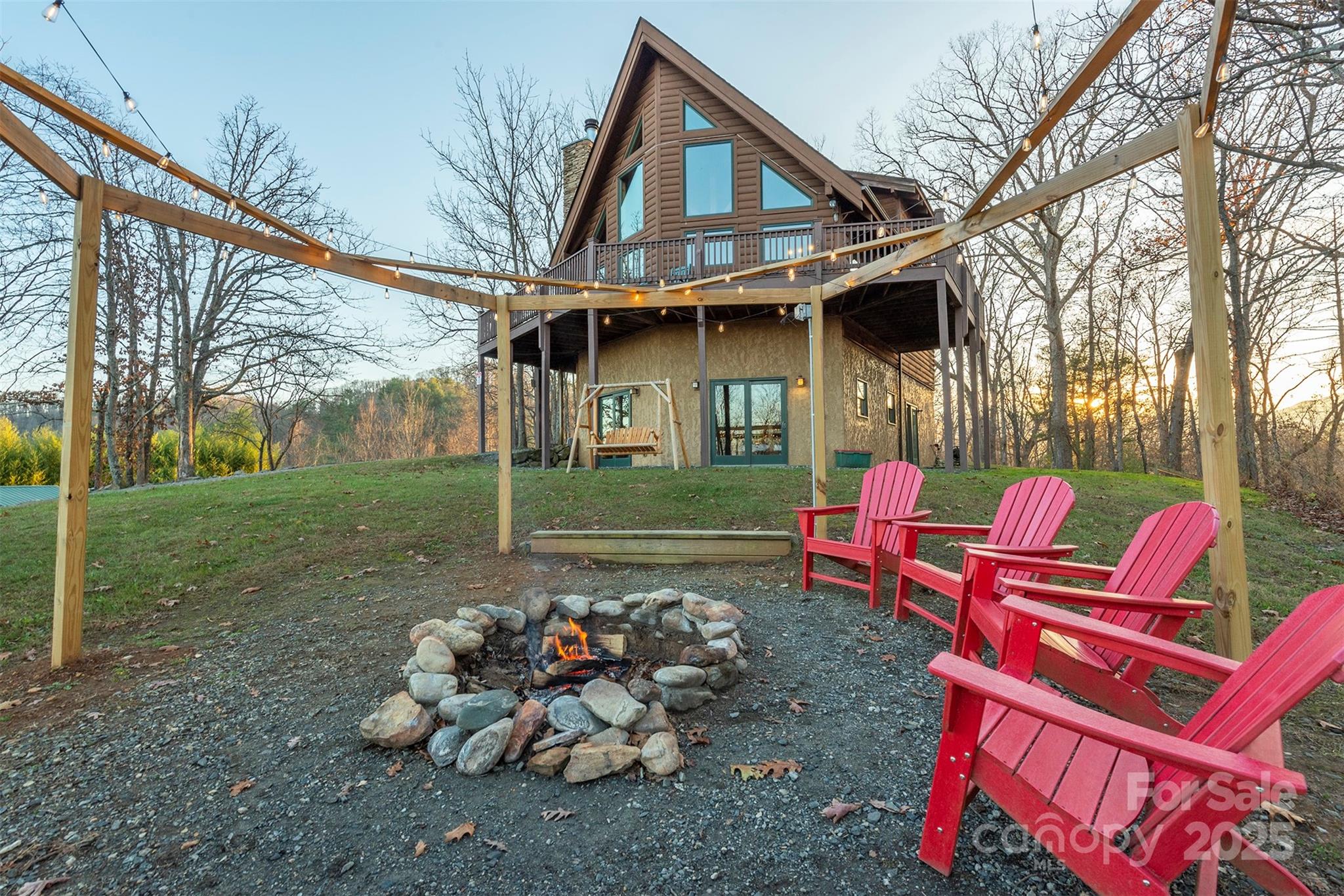 395 Dry Pond Road Marshall, NC 28753 - Photo 7 of 47 a backyard of a house with fire pit and chairs