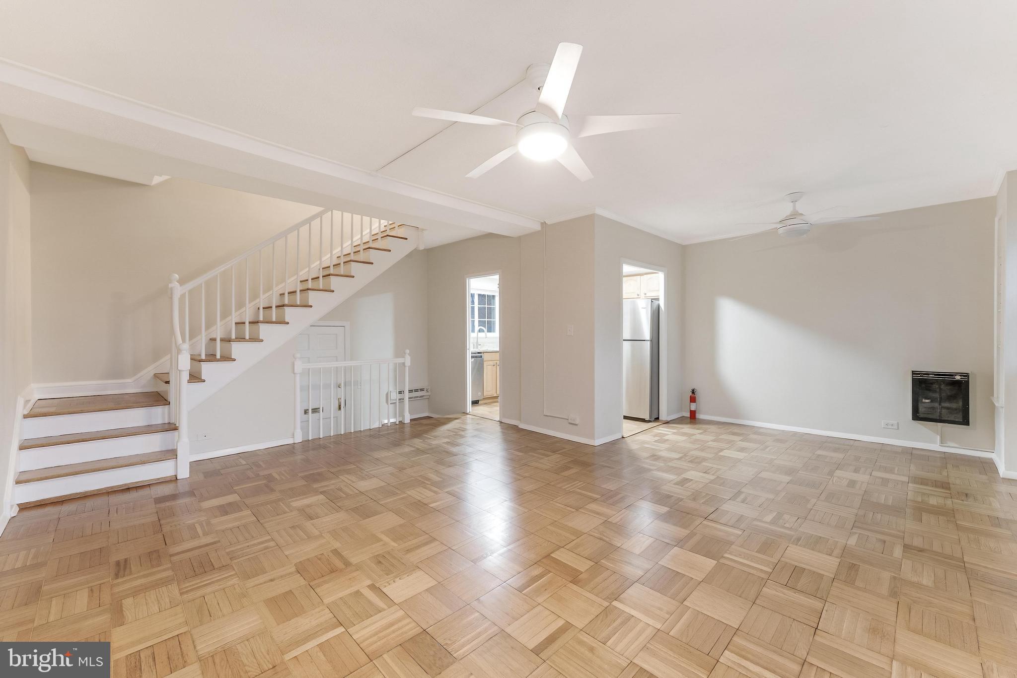 3228 Wellington Road Alexandria, VA 22302 - Photo 14 of 20 a view of an empty room with staircase and a ceiling fan