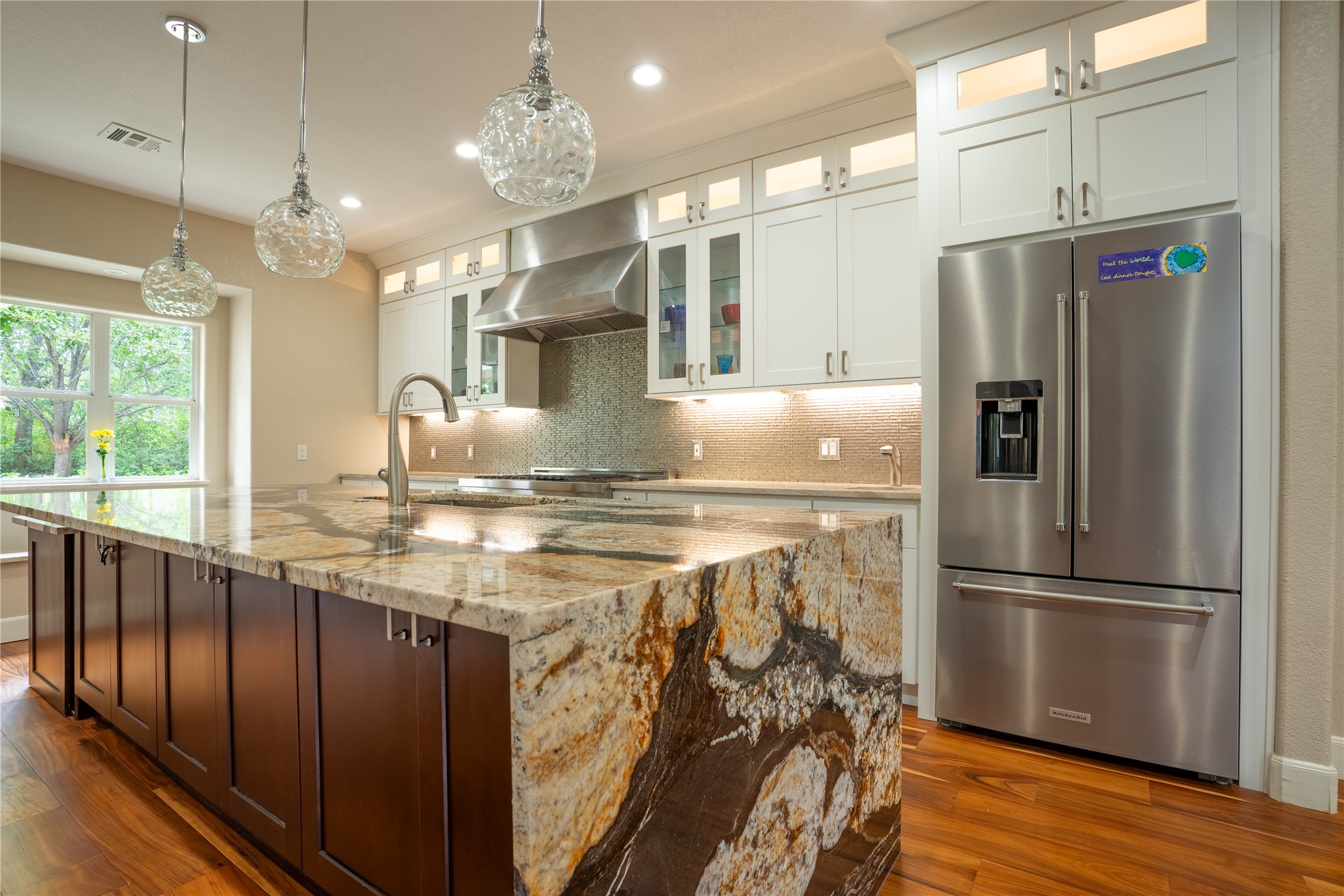 13800 Lone Rider Trail Austin, TX 78738 - Photo 10 of 32 A chef's kitchen showcasing a bold granite island and stainless steel appliances.