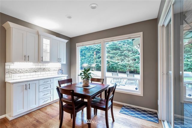 a view of a dining room with a table and chairs