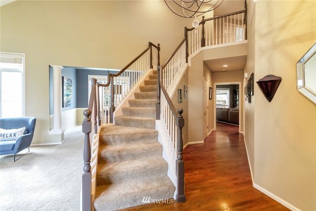 a view of entryway and hall with wooden floor