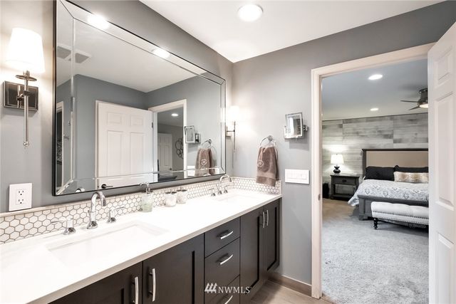 a spacious bathroom with a double vanity sink and a mirror