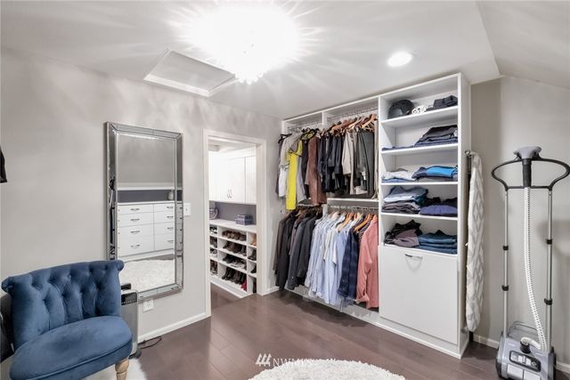 a view of walk in closet with clothes and shoes