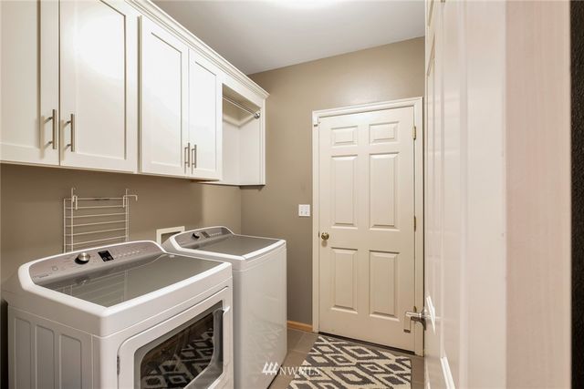 a view of a kitchen with sink and cabinets