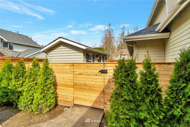 a view of a house with a small yard and plants