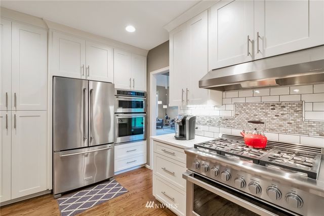 a kitchen with granite countertop a refrigerator and a stove