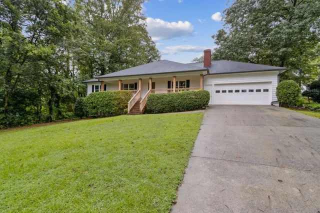 a view of house with yard and green space