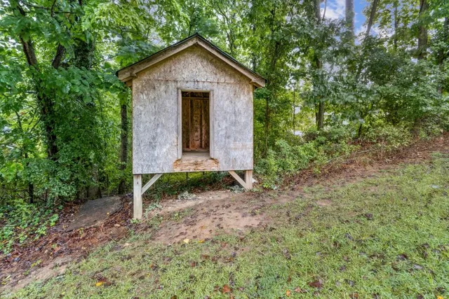 a view of a house with backyard and sitting area