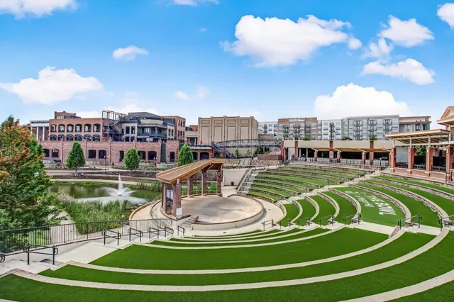 a front view of a house with garden and sitting area