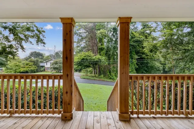 a view of balcony with wooden floor