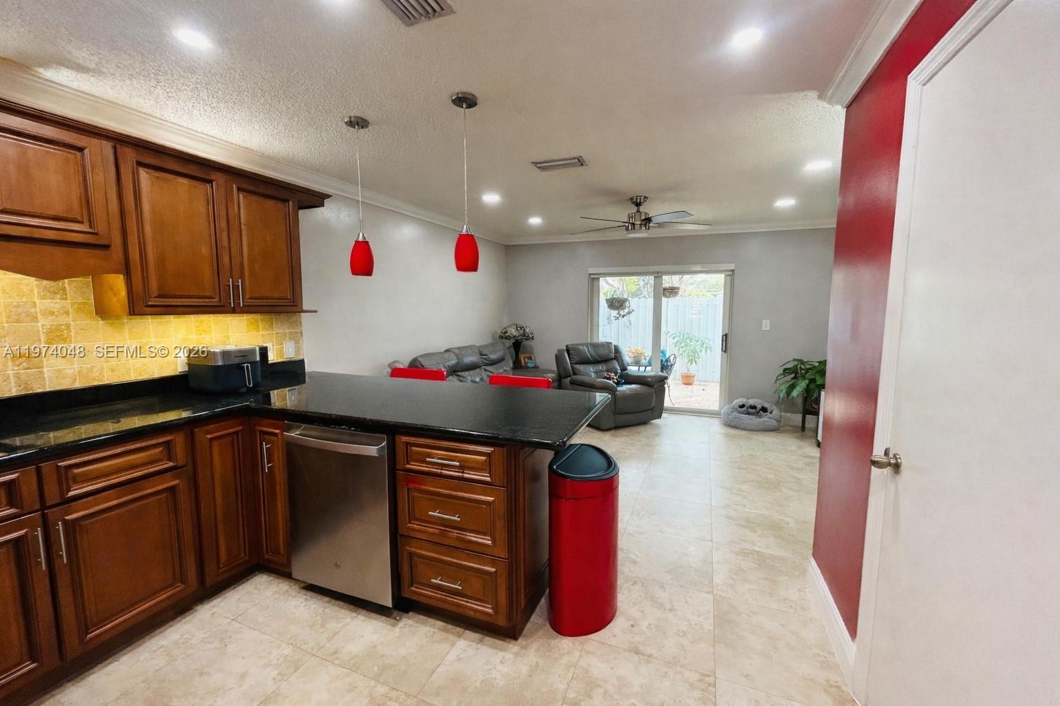 13890 Southwest 64th Street Miami, FL 33183 - Photo 11 of 23 a kitchen with granite countertop a sink and cabinets