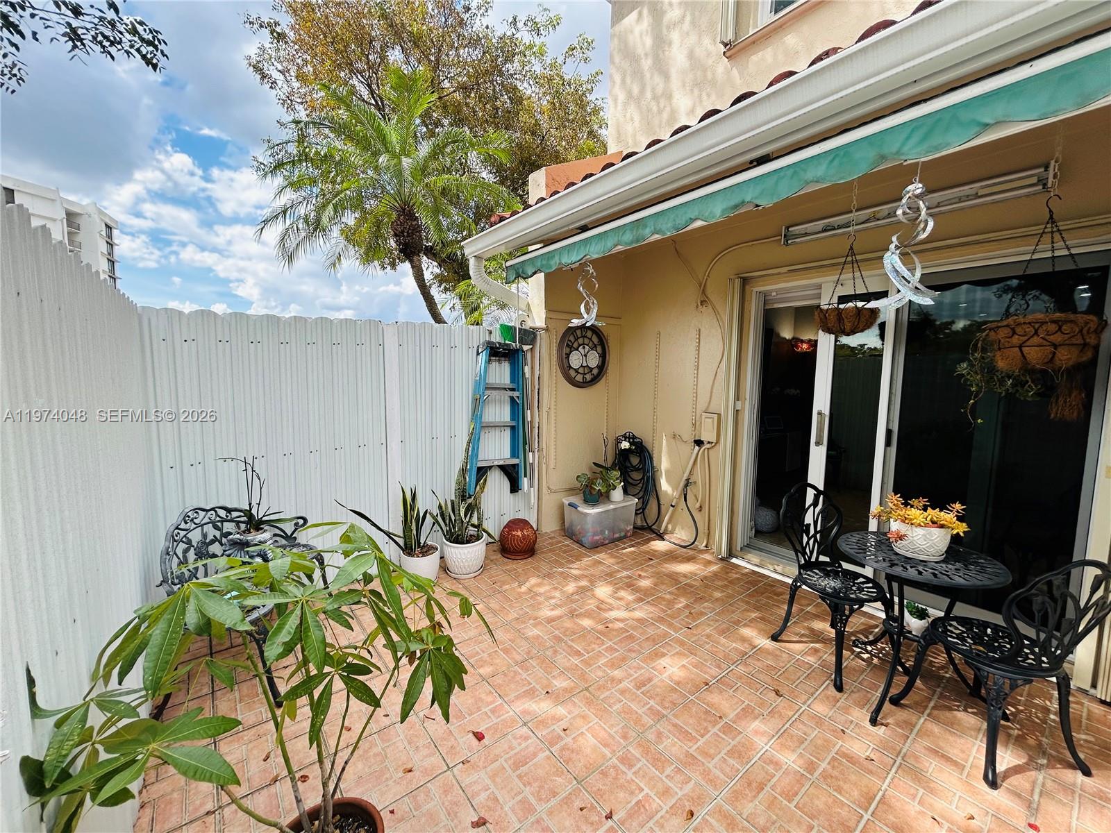 13890 Southwest 64th Street Miami, FL 33183 - Photo 13 of 23 a view of a chairs and table in a patio