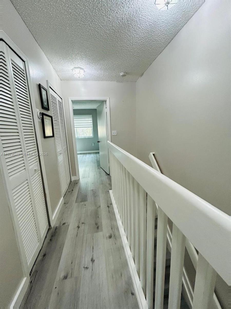 13890 Southwest 64th Street Miami, FL 33183 - Photo 16 of 23 a view of a hallway with wooden floor