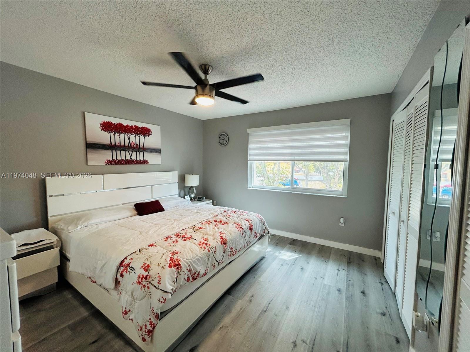 13890 Southwest 64th Street Miami, FL 33183 - Photo 2 of 23 a bedroom with a large bed and a window