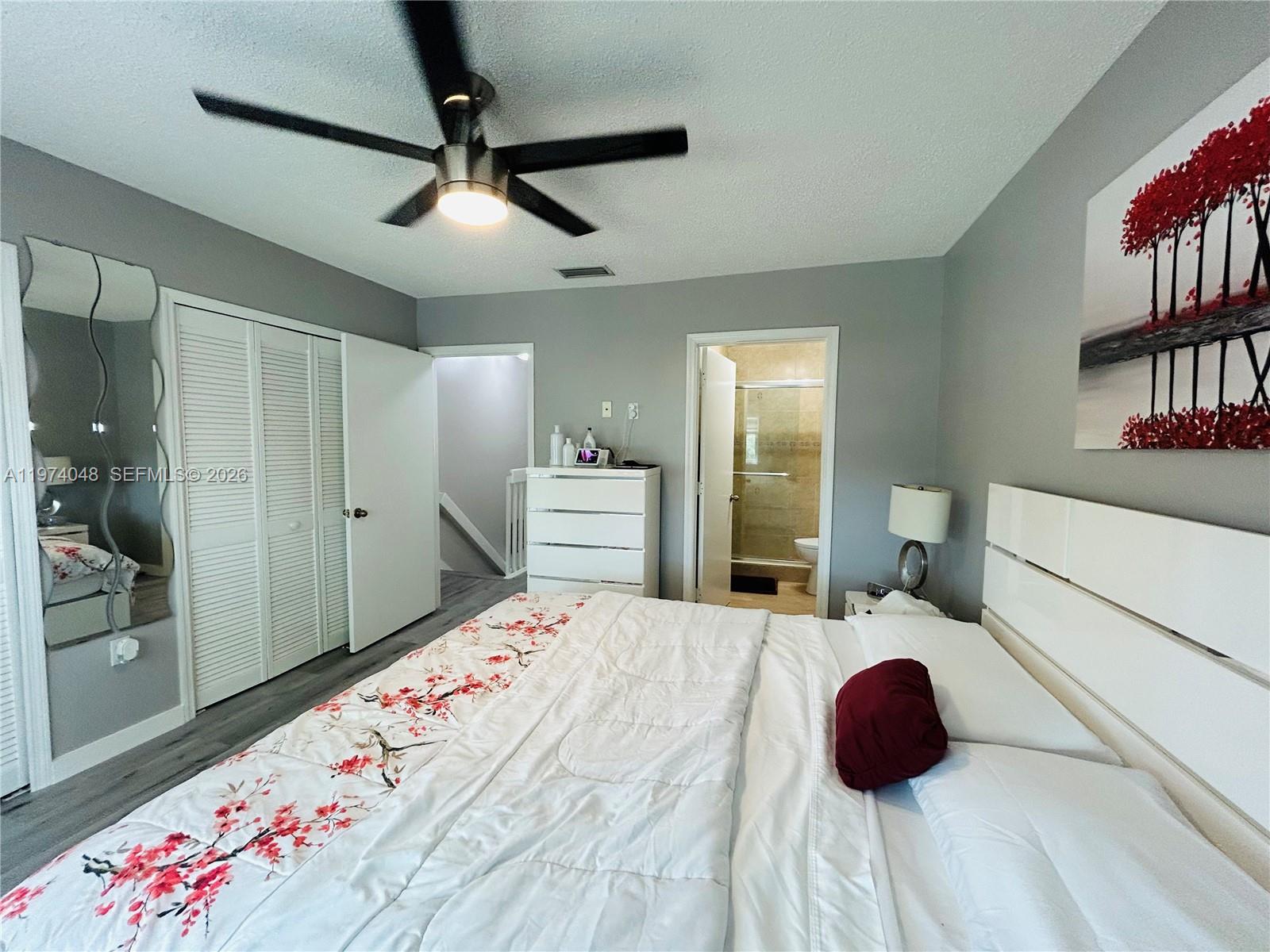 13890 Southwest 64th Street Miami, FL 33183 - Photo 3 of 23 a bedroom with a bed and a chandelier