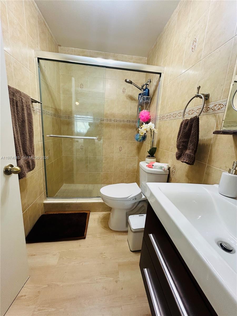 13890 Southwest 64th Street Miami, FL 33183 - Photo 4 of 23 a bathroom with a sink toilet and shower
