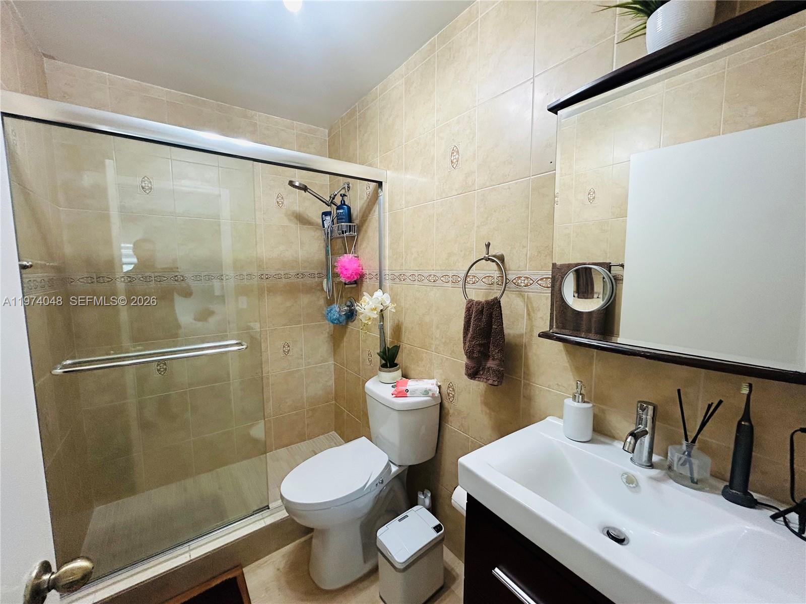 13890 Southwest 64th Street Miami, FL 33183 - Photo 5 of 23 a bathroom with a sink toilet and shower