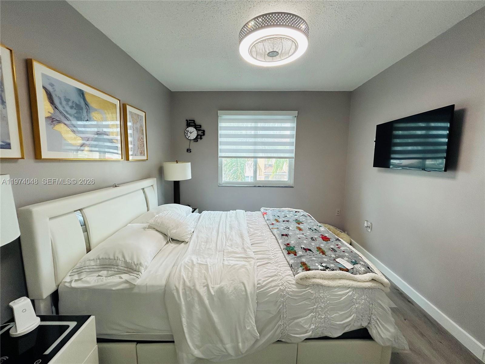 13890 Southwest 64th Street Miami, FL 33183 - Photo 6 of 23 a bedroom with a bed and a window