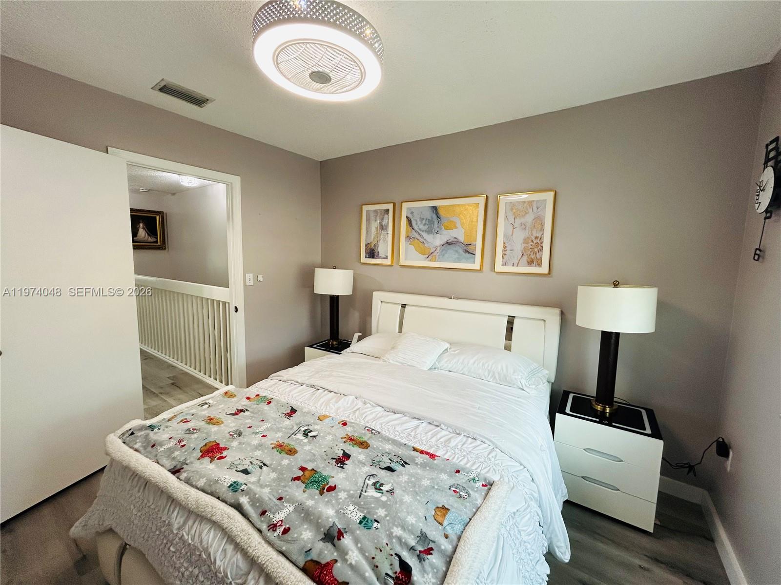 13890 Southwest 64th Street Miami, FL 33183 - Photo 7 of 23 a bedroom with a bed and a lamp on table