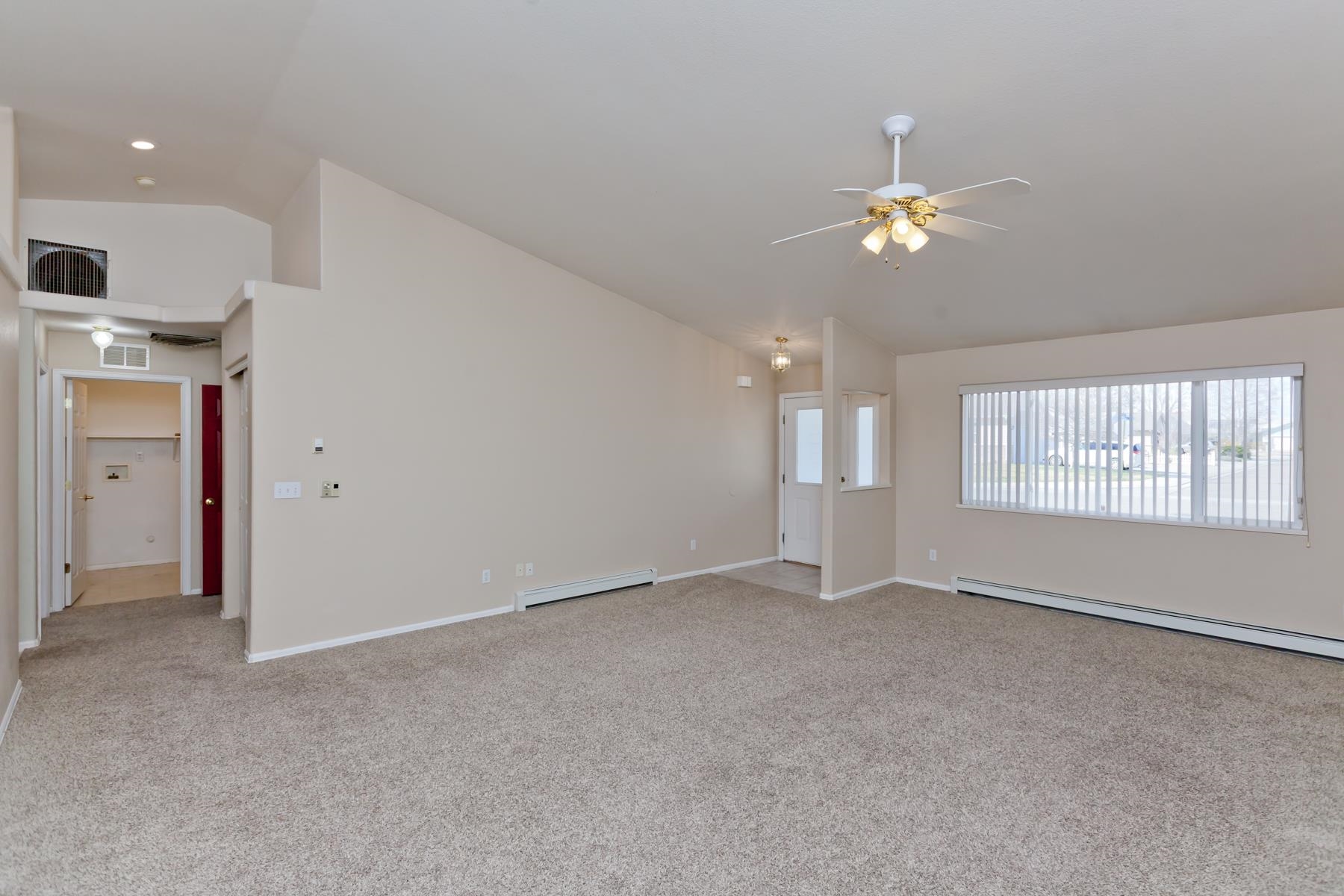 340 Elderberry Drive Fruita, CO 81521 - Photo 2 of 42 an empty room with windows and chandelier fan