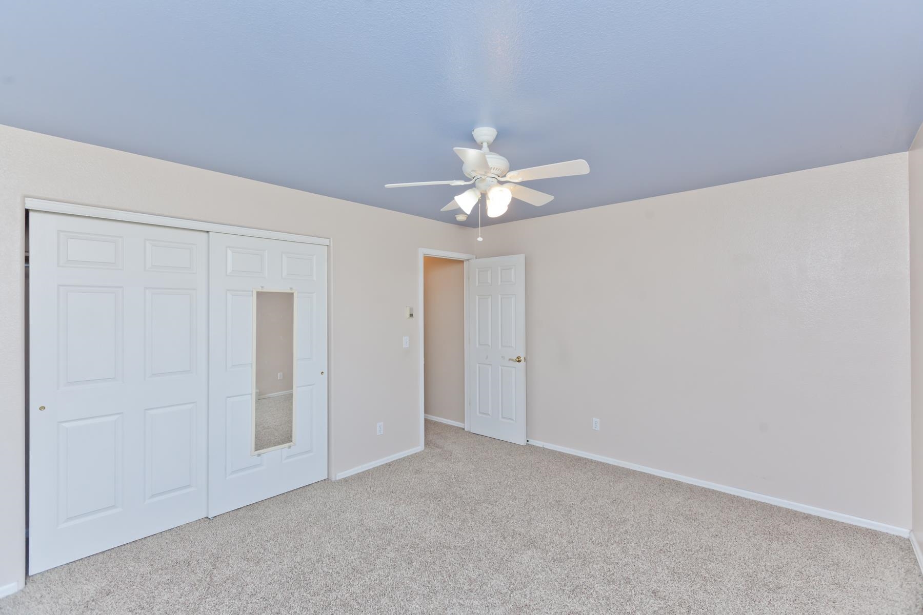 340 Elderberry Drive Fruita, CO 81521 - Photo 25 of 42 a view of an empty room with a chandelier fan