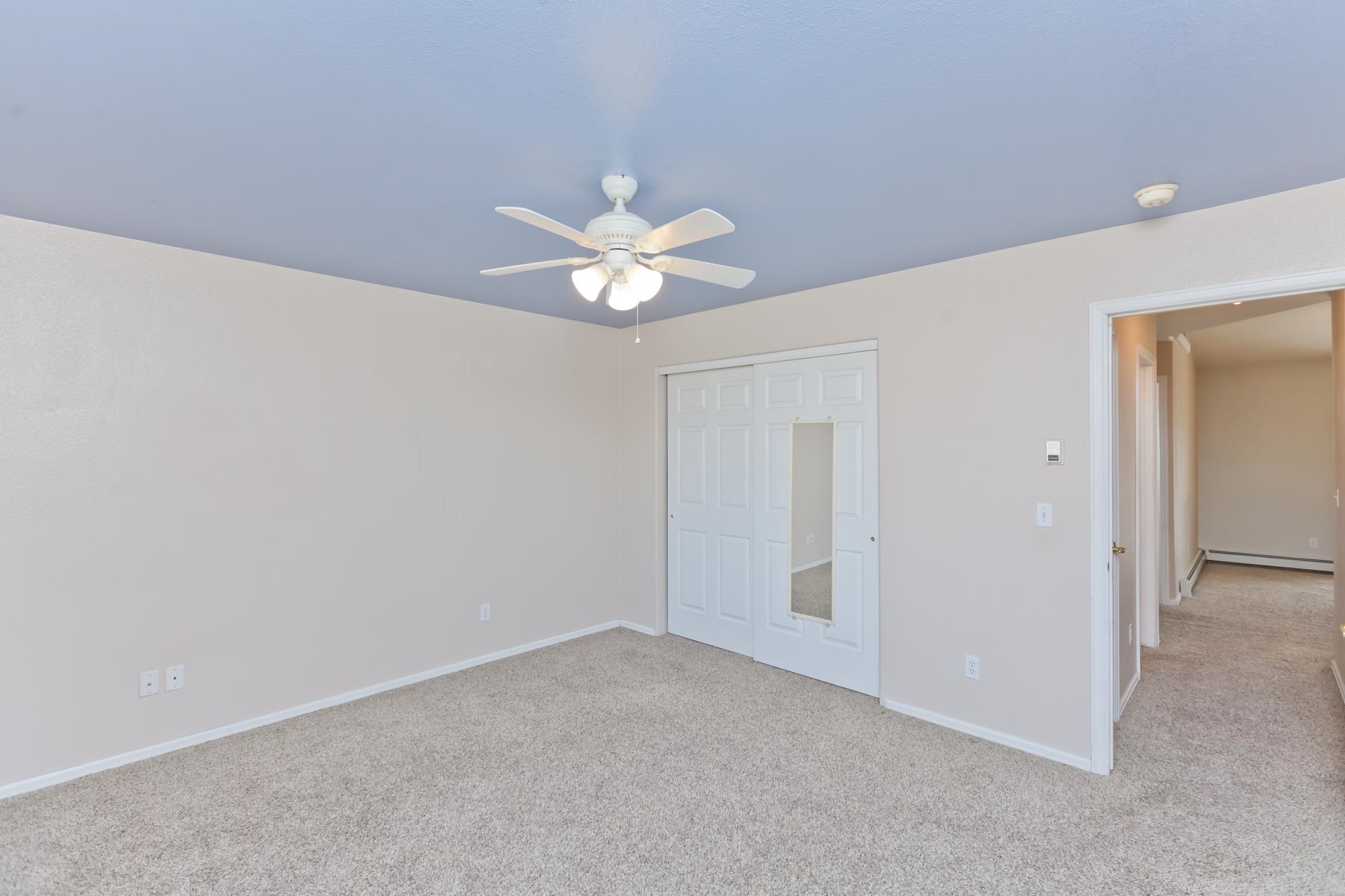 340 Elderberry Drive Fruita, CO 81521 - Photo 26 of 42 an empty room with a ceiling fan and a window