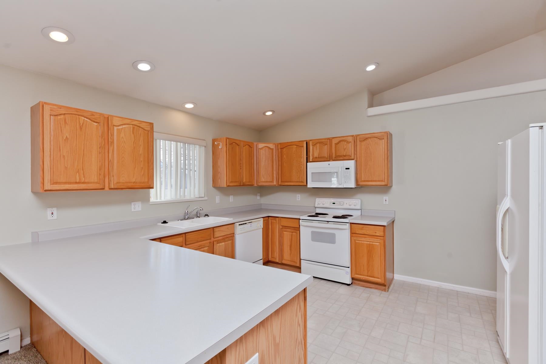 340 Elderberry Drive Fruita, CO 81521 - Photo 8 of 42 a kitchen with stainless steel appliances granite countertop a sink and a refrigerator