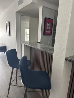a view of a hallway with furniture and a window