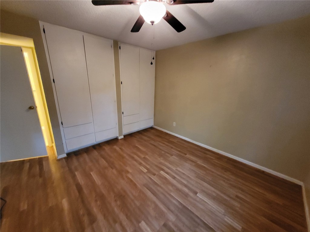 150 Ligon Street, Unit 1001 Clemson, SC 29631 - Photo 20 of 29 Well-lit room with wood flooring and built-in storage offers practical living.