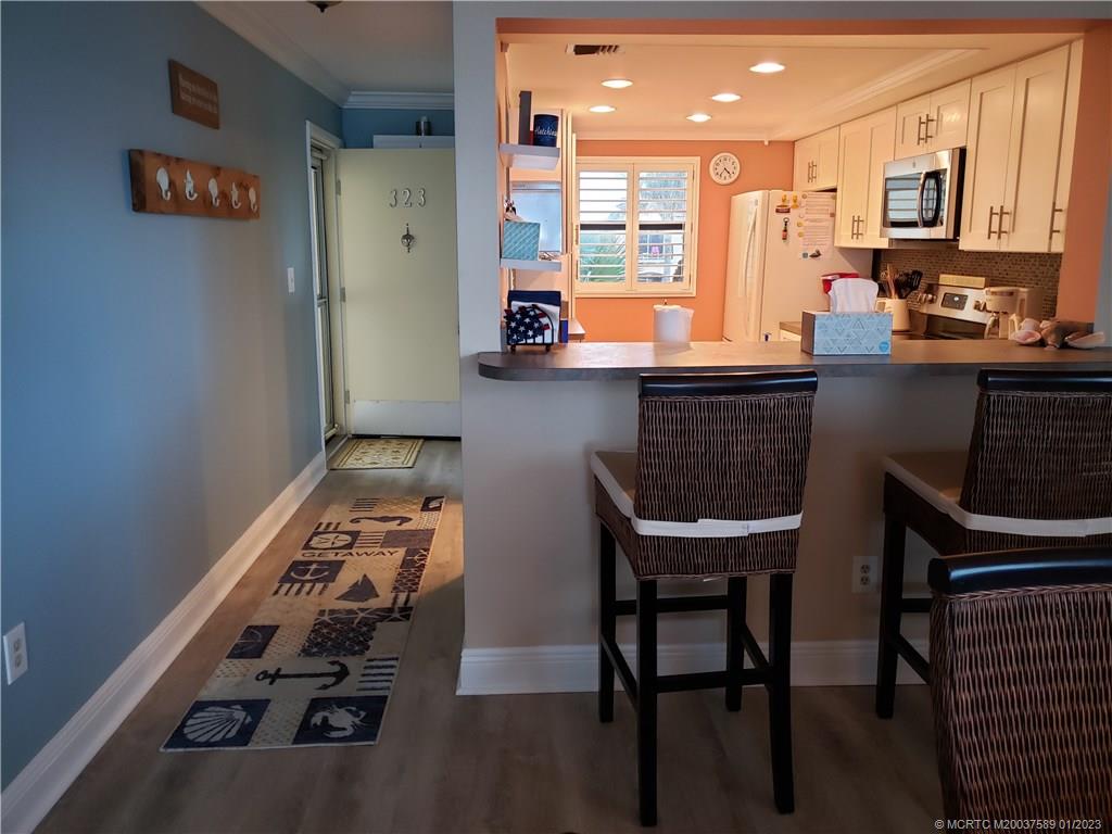 7440 South Ocean Drive, Unit 323A Jensen Beach, FL 34957 - Photo 2 of 12 a kitchen with a table and chairs in it