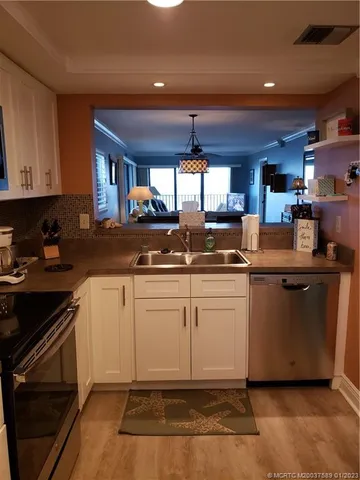 a kitchen with a sink cabinets and window