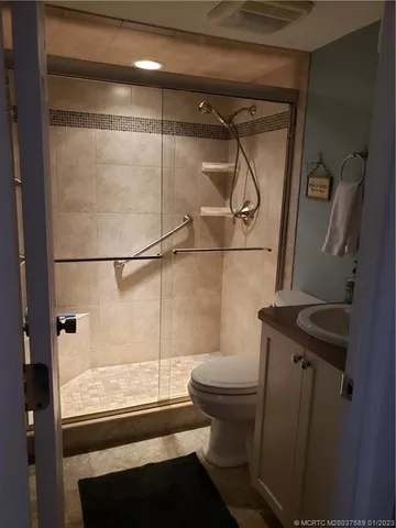 a bathroom with a shower a toilet and sink