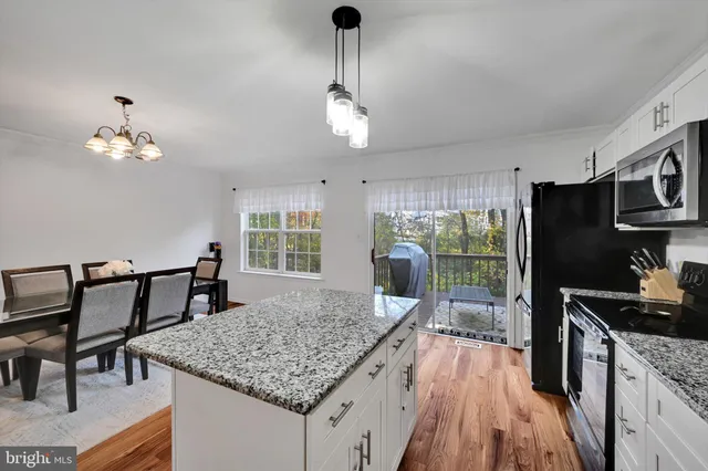a kitchen with sink table and chairs