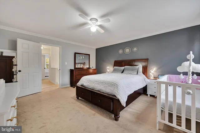 a spacious bedroom with a bed and a chandelier