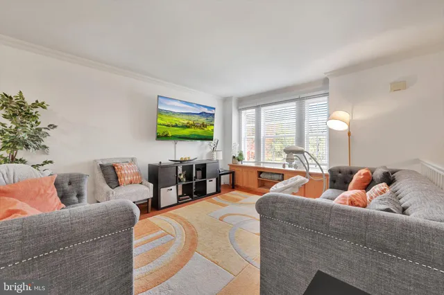 a living room with fireplace furniture and a large window