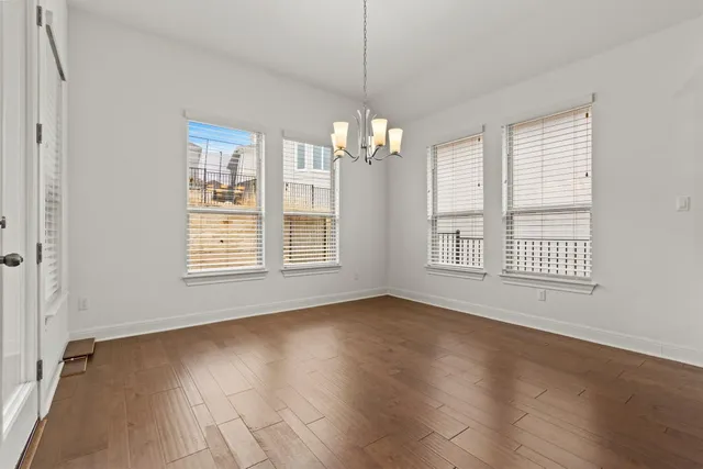 a view of livingroom with window hardwood floor and kitchen view