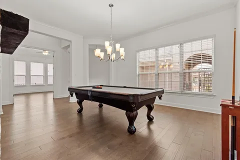 a living room with a table and a chandelier