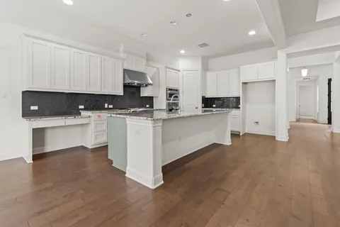 a kitchen with stainless steel appliances a refrigerator sink and cabinets