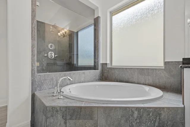 a bathroom with a bathtub and a sink