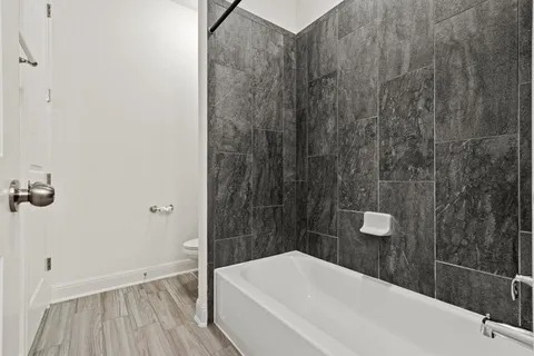 a bathroom with a bathtub and shower